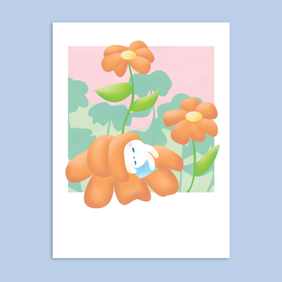 Image of a bunny using an orange flower as a blanket.